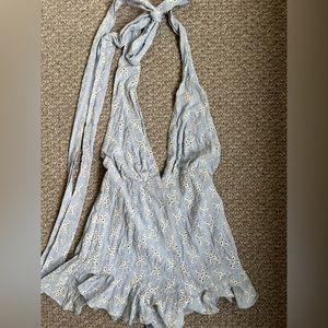 Baby blue romper with white embroidery. Small flower detail. Tie neck & low back